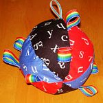 For babies, try a stuffed ball with ribbon tags for grabbing.