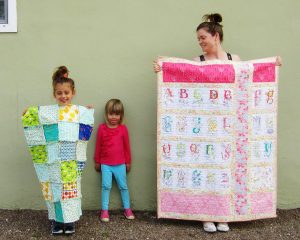 Here is my then five year old daughter showing off the rag quilt she helped to sew.