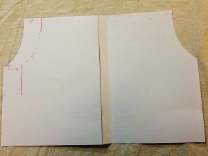 Paper diagram illustrating marking new arms eye and side seam lines on the shirt back piece.