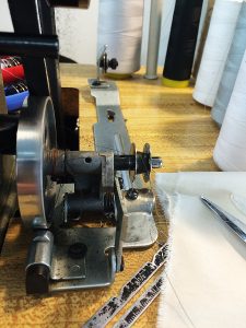 You’ll need to engage the bobbin by pushing it backwards so that the wheel connects with the belt of the machine.