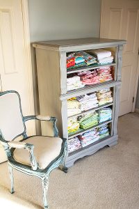 One is to take the drawers out of a dresser, and once the furniture has been treated so that it looks finished and ready, fabric can be stashed where the drawers used to be.