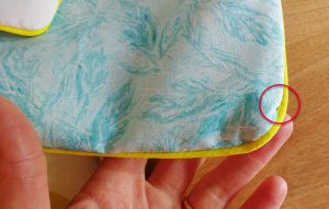 Carefully inspect all along the seams and make sure no thread is showing from the piping like you see here.