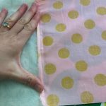 Here I folded the cotton fabric seam over the minky fabric and then placed a scrap of fabric over both.