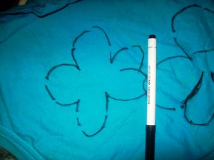 Take a marker (use a fabric-friendly writing utensil!) & trace the patterns of flowers, butterflies, clouds, the sun, a house…