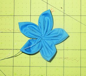 Sew the last petal to the first, then neaten center.
