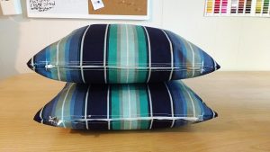 Two puffy pillow cases with zippered closes that are the same front & back.