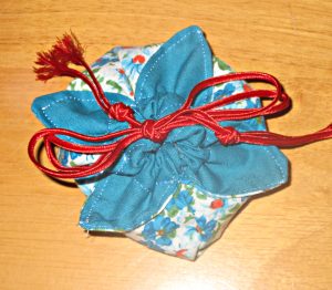 Small pouch to hold a gift of handmade bracelets and earrings, made from 8" squares.